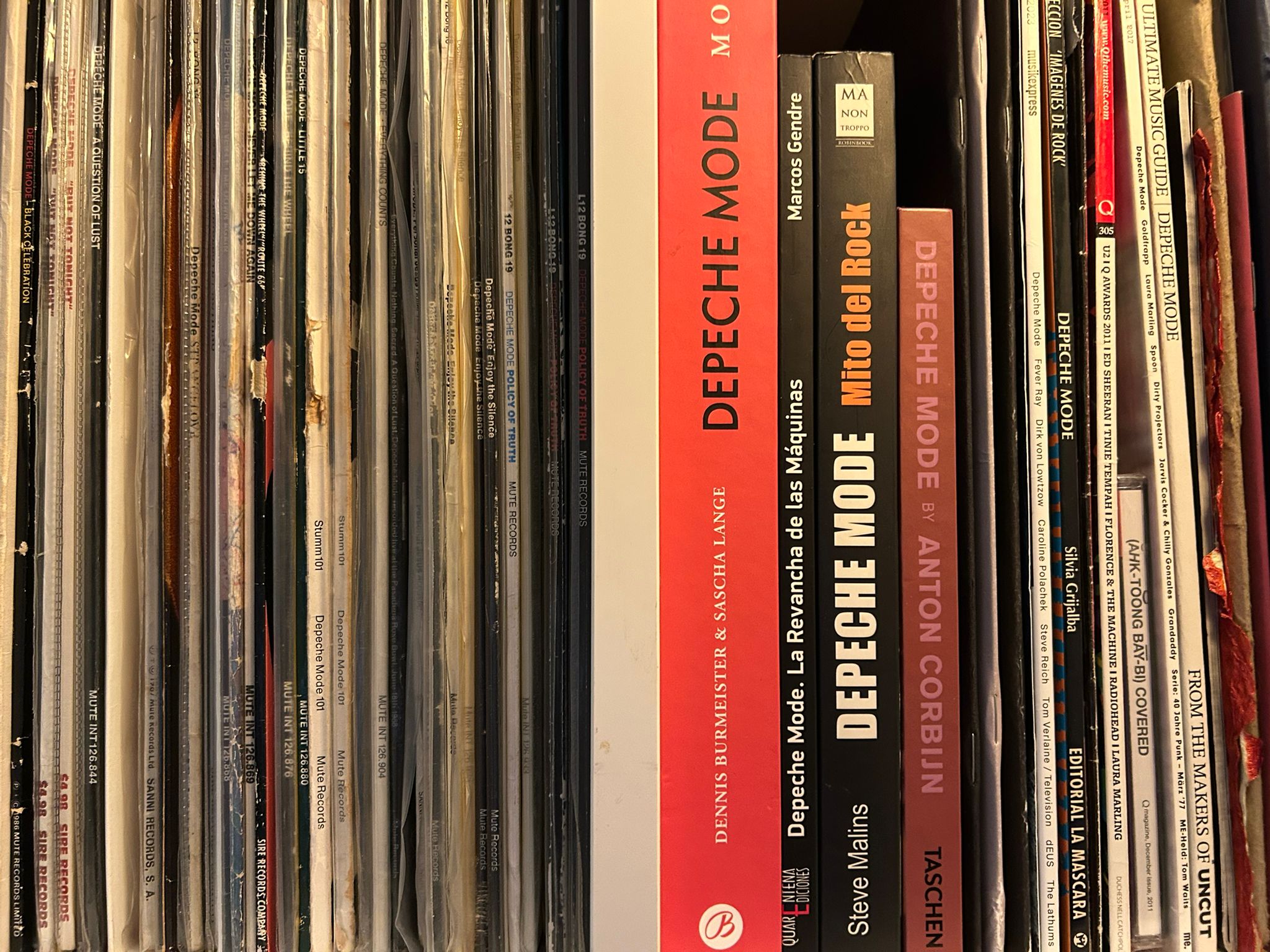 Colección de merchandising musical de Depeche Mode con libros y vinilos